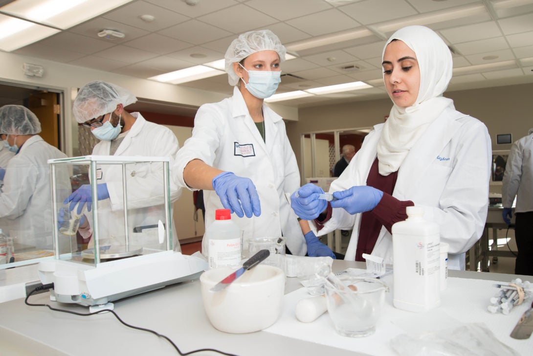 Students in lab with white coats