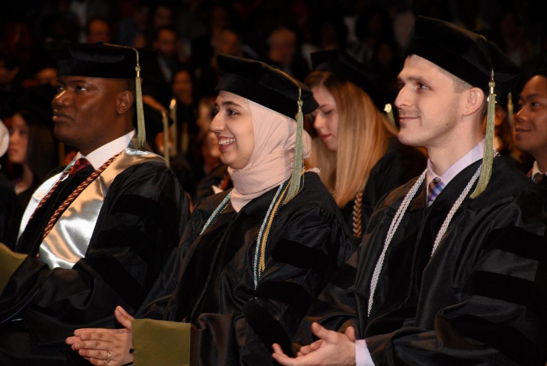 Pharmacy students applauding during graduation ceremony