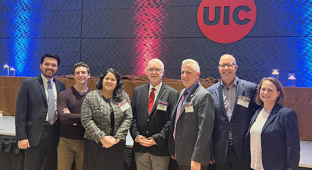 Matthew Rim, Brian Murphy, Marianne Pop, President Tim Killeen, Kevin Rynn, Mike Koronkowski, Joanna Burdette pose together for a photo after the UIC Faculty Awards Ceremony