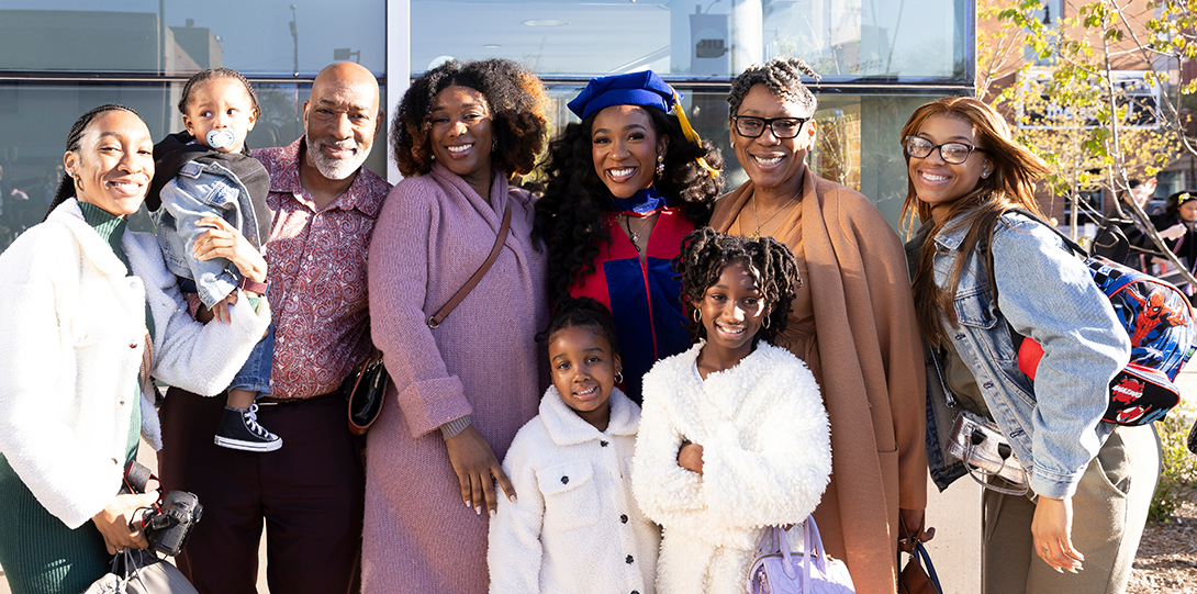 PhD graduate Destiny Durante with her family stand outside the UIC Dorin Forum