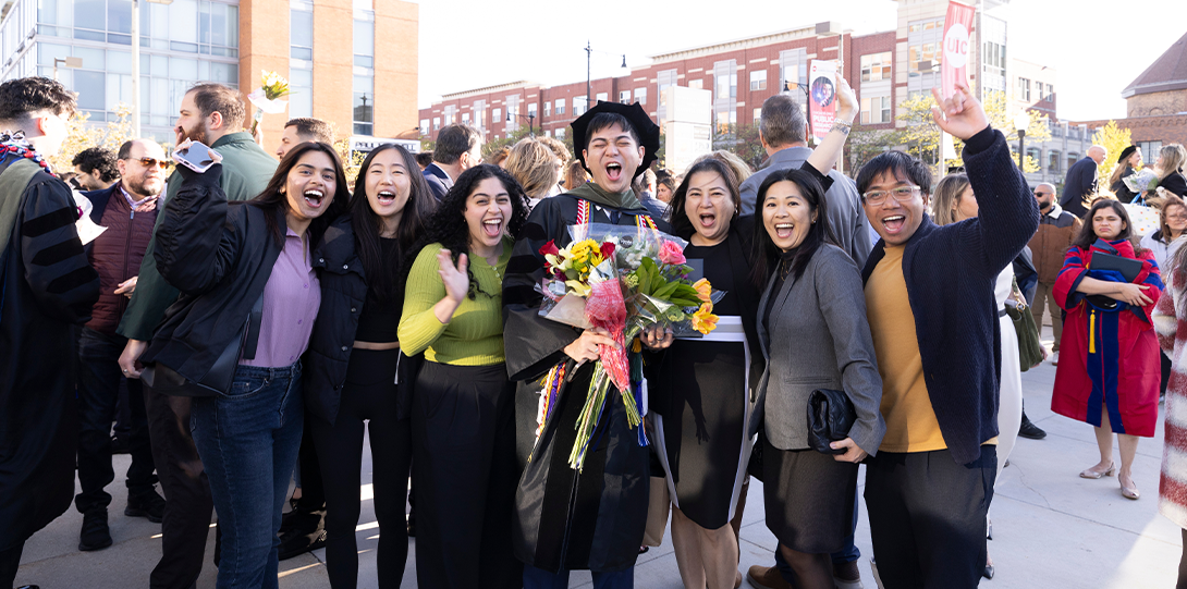 UIC PharmD grad outside Dorin Forum with their family